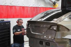 Collision Repair Services - Tech Performing Aluminum Repair on Tesla